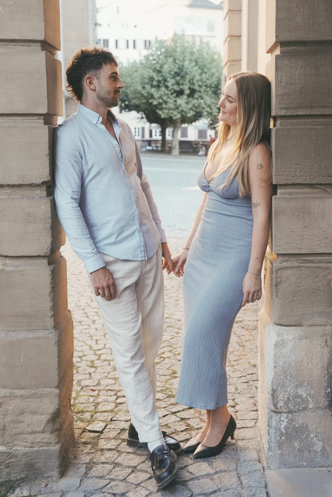 Paar steht sich gegenüber Hand haltend bei Verlobungsshooting in Tübingen